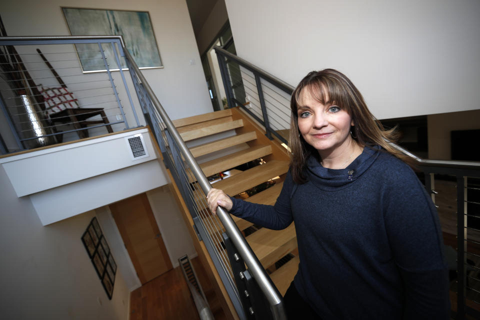 Coni Sanders, whose father was a teacher killed in the 1999 shooting at Columbine High School, poses for a photo at her home Saturday, March 16, 2019, in Denver. A growing movement is urging news organizations to avoid naming the gunmen responsible for mass shootings. The idea is to avoid inspiring more shooters who seek infamy and notoriety. "The media was so fascinated, and so was our country and the world, that they really grasped onto this every detail. Time and time again, we couldn’t escape it," Sanders said. (AP Photo/David Zalubowski)