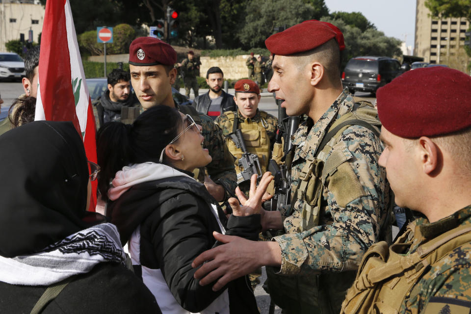 Army soldiers scuffle with anti-government protesters blocking a road leading to the parliament building in Beirut, Lebanon, Monday, Jan. 27, 2020. Lebanese security forces scuffled Monday with protesters near the parliament building in downtown Beirut, where lawmakers are scheduled to begin a two-day discussion and later approval of the state budget amid a crippling financial crisis. (AP Photo/Bilal Hussein)