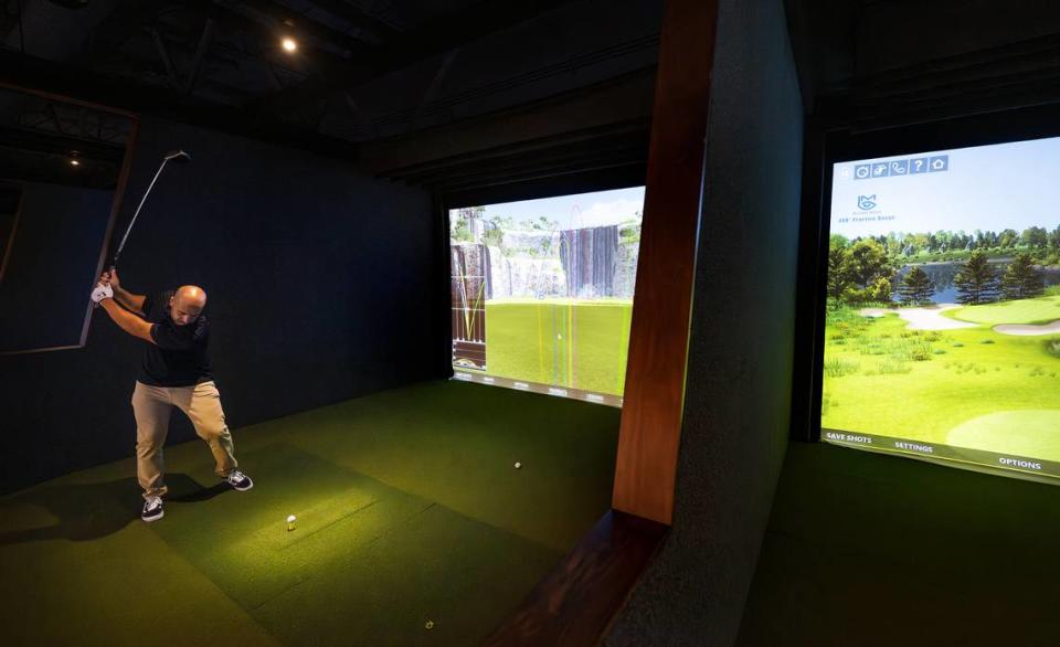 Alex Araujo hits on the virtual driving range at Swing Center Indoor Golf in Modesto, Calif., Wednesday, August 23, 2023.