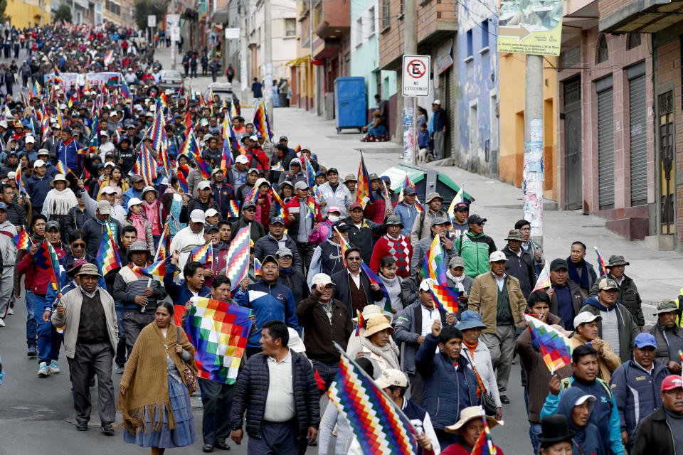 Backers of former President Evo Morales march in La Paz, Bolivia, Wednesday, Nov. 13, 2019. Morales flew to Mexico Tuesday after resigning on Nov. 10, following weeks of violent protests fed by allegations of electoral fraud in a presidential election which he claimed to have won. (AP Photo/Natacha Pisarenko)