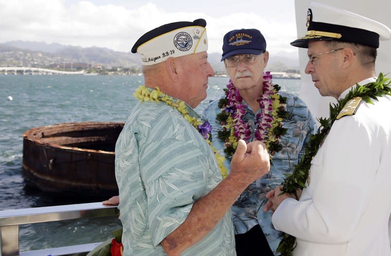 HONOLULU – DECEMBER 7: With the submerged smoke stack of the USS Arizona looming in the background, Pearl Harbor survivors (L-R) Lou Conter, Ward Witmore, and current US Pacific Fleet Chief of Naval Operations Admiral Michael G. Mullen talk about the Japanese surprise attack on Pearl Harbor aboard the USS Arizona Memorial during the ceremony honoring the 64th anniversary of the surprise attack on Pearl Harbor December 7, 2005 at Pearl Harbor, Hawaii. Around the country, Pearl Harbor survivors and others paid tribute to those lost during the December 7, 1941 Japanese bombing of Pearl Harbor. (Photo by Marco Garcia/Getty Images)