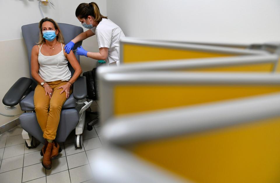 A medical staff receives a dose of the Pfizer-BioNTech Covid-19 vaccine on January 8, 2021 at the Cavale Blanche hospital in Brest, western France during a vaccination operation of the medical staff against the Covid-19 disease. (Photo by Fred TANNEAU / AFP) (Photo by FRED TANNEAU/AFP via Getty Images)