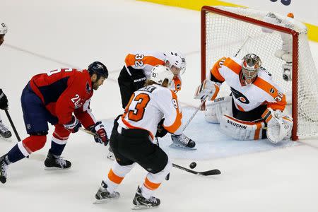 Apr 22, 2016; Washington, DC, USA; Philadelphia Flyers goalie Michal Neuvirth (30) prepares to make a save on Washington Capitals right wing Daniel Winnik (26) in the third period in game five of the first round of the 2016 Stanley Cup Playoffs at Verizon Center. Mandatory Credit: Geoff Burke-USA TODAY Sports