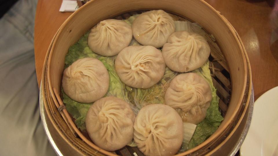 Eight unexpectedly huge soup dumplings on unexpected cabbage leaves. (Quartz/Siyi Chen)