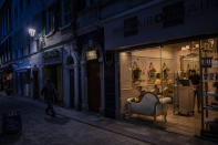 A man works in a barbershop in Gibraltar, Thursday, March 4, 2021. Gibraltar, a densely populated narrow peninsula at the mouth of the Mediterranean Sea, is emerging from a two-month lockdown with the help of a successful vaccination rollout. The British overseas territory is currently on track to complete by the end of March the vaccination of both its residents over age 16 and its vast imported workforce. But the recent easing of restrictions, in what authorities have christened “Operation Freedom,” leaves Gibraltar with the challenge of reopening to a globalized world with unequal access to coronavirus jabs. (AP Photo/Bernat Armangue)