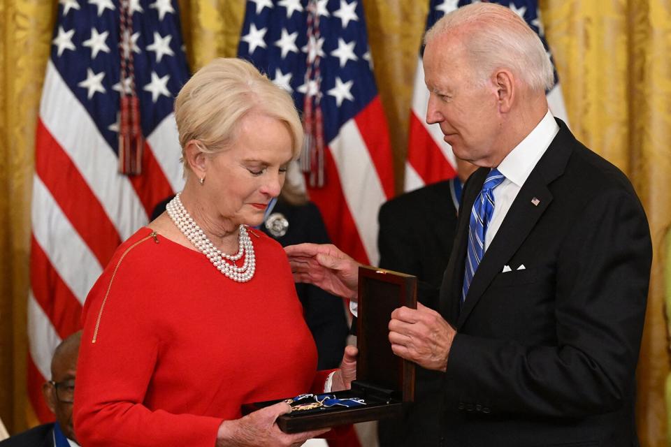 US President Joe Biden presents Cindy McCain (L), the widdow of former Senator and presidential candidate John McCain, posthumously with the Presidential Medal of Freedom, the nation's highest civilian honor, during a ceremony honoring 17 recipients, in the East Room of the White House in Washington, DC, July 7, 2022.