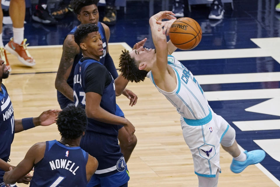 Charlotte Hornets' LaMelo Ball, right, loses the ball after being fouled by Minnesota Timberwolves' Jaylen Nowell (4) in the second half of an NBA basketball game Wednesday, March 3, 2021, in Minneapolis. (AP Photo/Jim Mone)