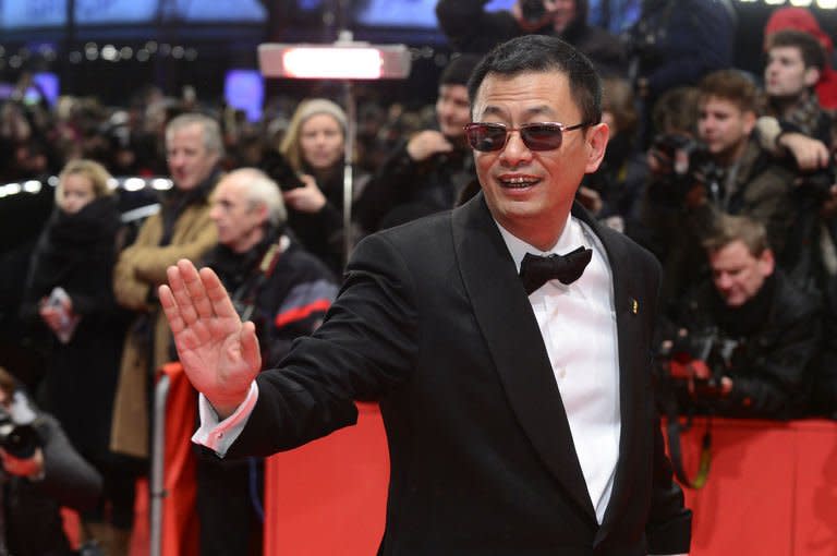 Chinese director Wong Kar Wai poses on the red carpet on arrival for the opening film of the Berlinale film festival, "Yi dai zong shi" ("The Grandmaster") in Berlin on February 7, 2013