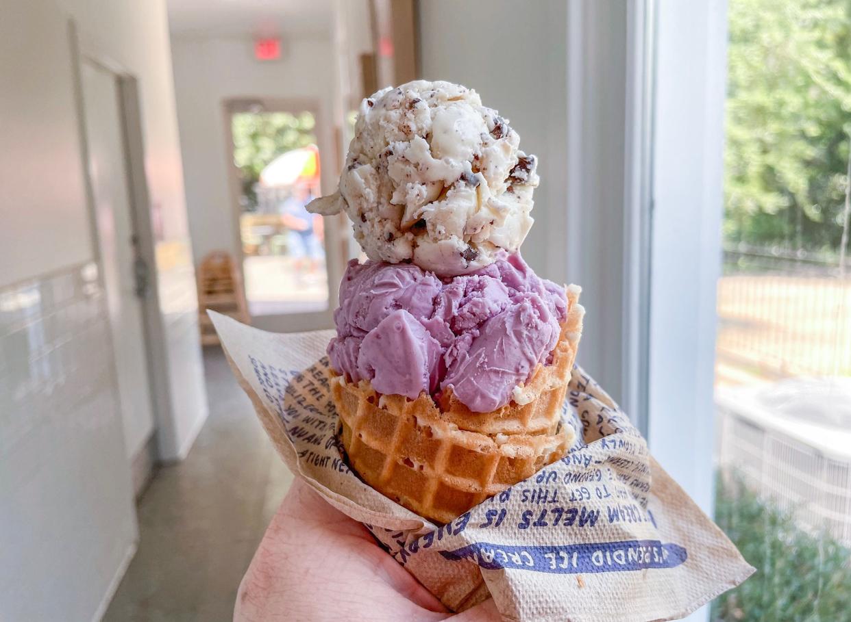 A scoop of salted licorice sits on top of a scoop of wildberry lavender at Jeni's Splendid Ice Creams in Athens, Ga. on Tuesday, Aug. 1, 2023.