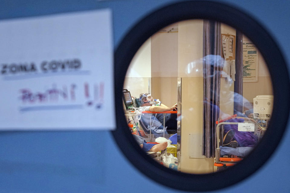 A patient breathes through an oxygen mask in a COVID-19 isolation room at the University Emergency Hospital in Bucharest, Romania, Friday, Oct. 22, 2021. In Romania, a European Union country of around 19 million, only 35% of adults are fully inoculated against COVID-19 compared to an EU average of 74%.(AP Photo/Vadim Ghirda)