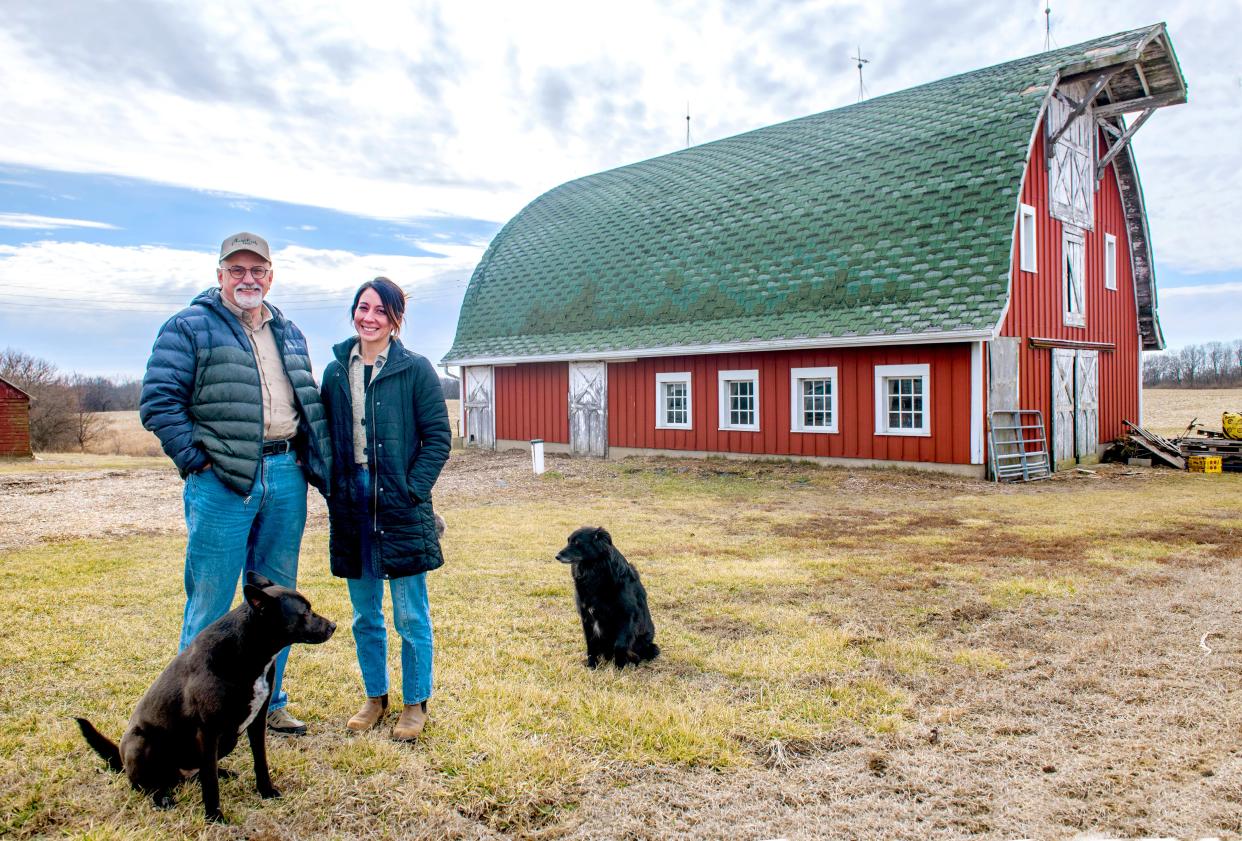 Farm owner Dave Bishop, left, and tenant Kira Santiago of Kira's Flowers stand near a Sears and Roebuck dairy barn built in 1927 on Bishop's property on the edge of East Peoria. Bishop and Santiago have mounted a campaign to fund the restoration of the rundown barn, which suffers from a badly leaking roof.
