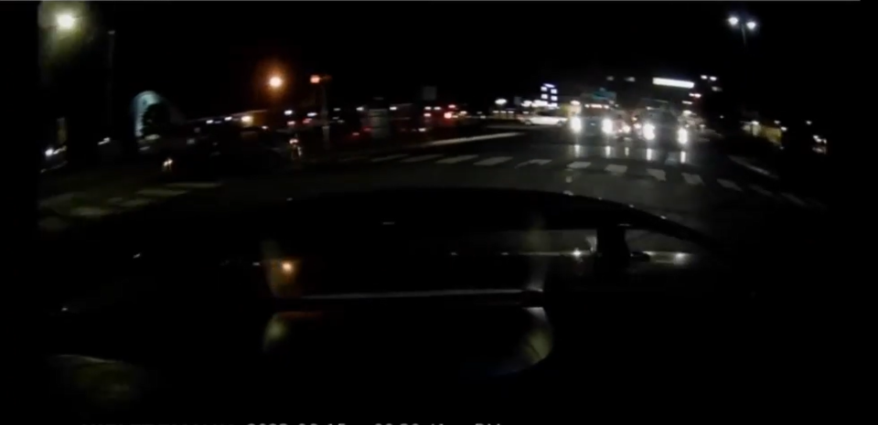 Rear dash witness video shows two DelDOT trucks (with headlights on) at the stoplight. Neither truck moved when the light turned green. Sanogo's car is behind the truck on the right.