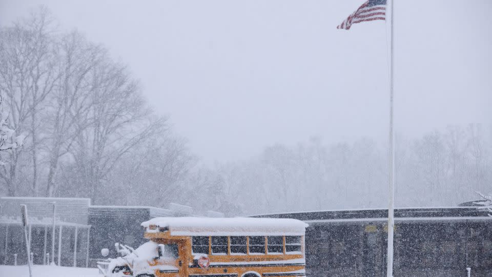 A school bus is covered in snow at the Northvale Public School in Northvale, New Jersey. - Kena Betancur/AFP/Getty Images