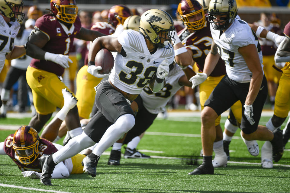 Purdue running back Dylan Downing (38) runs for a gain against Minnesota during the first half an NCAA college football game on Saturday, Oct. 1, 2022, in Minneapolis. Purdue won 20-10. (AP Photo/Craig Lassig)