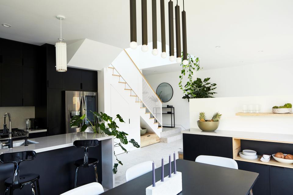 Interior of the dining, kitchen, and entry in the background. The bar/console was custom designed by Open for Humans.