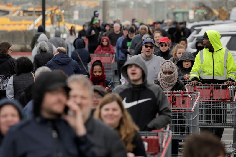 Shoppers line up before opening at a Costco store, following reports of coronavirus disease (COVID-19) cases in the country, in Seattle