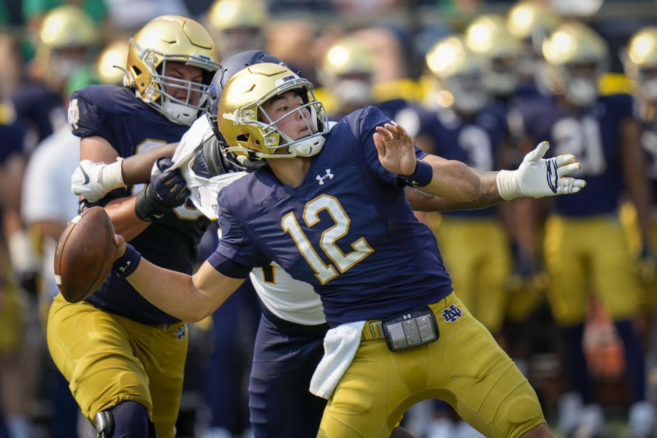 FILE - Notre Dame quarterback Tyler Buchner (12) throws while playing Toledo in the first half of an NCAA college football game in South Bend, Ind., on Sept. 11, 2021. New Notre Dame coach Marcus Freeman and quarterback Tyler Buchner are chasing history. It's been nearly 60 years since a first-year coach and a new starting quarterback joined forces to nearly win a national championship. (AP Photo/AJ Mast, File)