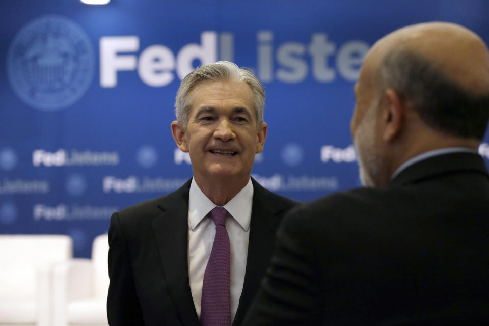 Federal Reserve Chairman Jerome Powell, left, talks to former Federal Reserve Chairs Ben Bernanke at a conference involving its review of its interest-rate policy strategy and communications, Tuesday, June 4, 2019, in Chicago. (AP Photo/Kiichiro Sato)