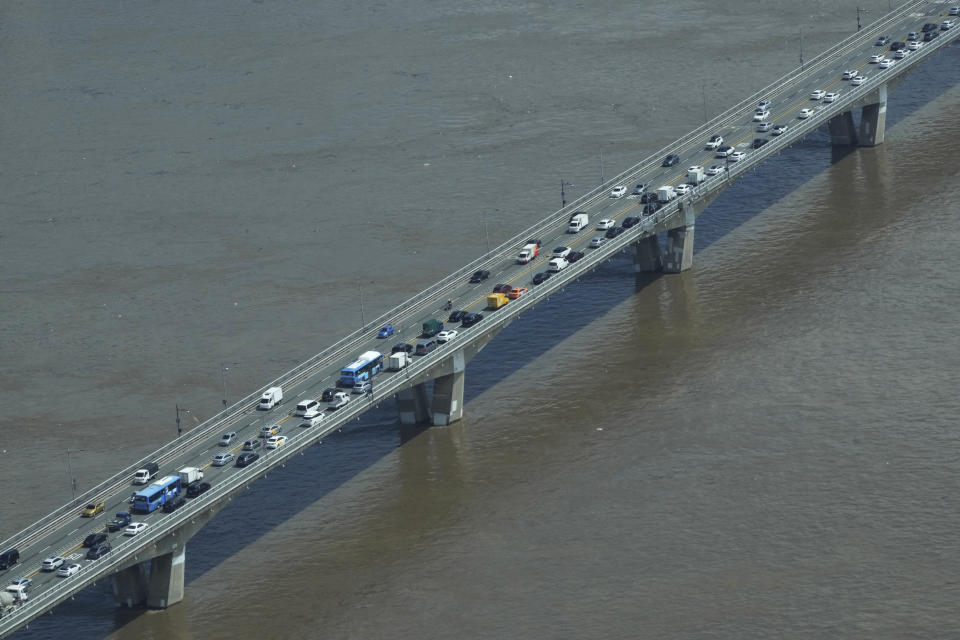 The Han River, swollen with floodwater, flows under a bridge in Seoul, South Korea, Wednesday, Aug. 10, 2022. Cleanup and recovery efforts gained pace in South Korea's greater capital region Wednesday as skies cleared after two days of record-breaking rainfall that unleashed flash floods, damaged thousands of buildings and roads and killed multiple people. (AP Photo/Ahn Young-joon)