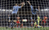 FILE - Uruguay's Luis Suarez, left, stops the ball with his hands to give away a penalty kick, during the World Cup quarterfinal soccer match between Uruguay and Ghana, at Soccer City in Johannesburg, South Africa, on July 2, 2010. (AP Photo/Ivan Sekretarev, File)