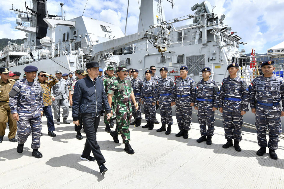 FILE - In this Jan. 8, 2020, file photo released by Indonesian Presidential Office, Indonesian President Joko Widodo, center, inspects troops during his visit at Indonesian Navy ship KRI Usman Harun at Selat Lampa Port, Natuna Islands, Indonesia. Widodo reaffirmed his country's sovereignty during a visit to a group of islands at the edge of the South China Sea that China claims as its traditional fishing area. (Agus Soeparto, Indonesian Presidential Office via AP, File)