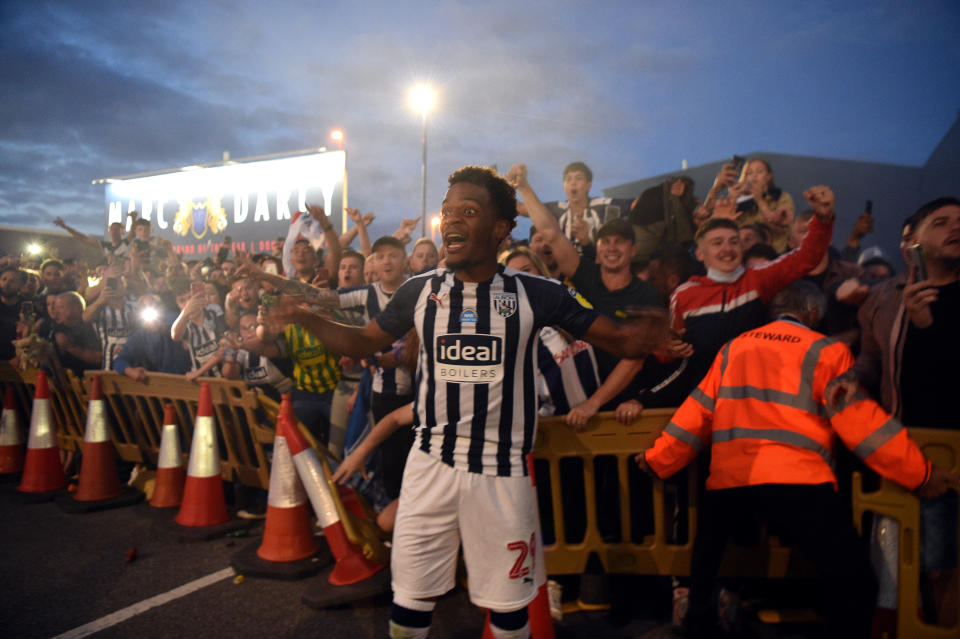 Grady Diangana, of West Bromwich Albion, celebrates with the fans outside the stadium after they were promoted to the Premier League.