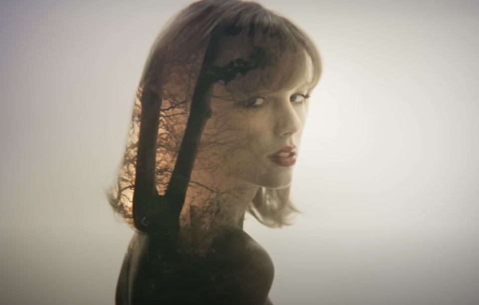 Profile of Taylor Swift with shadow of tree branches across her face
