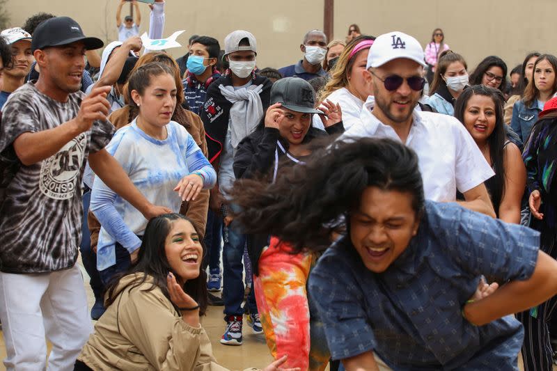 Migrants dance during an event named "Virtual Reality Baroque Opera" awaiting the result of their asylum request to U.S