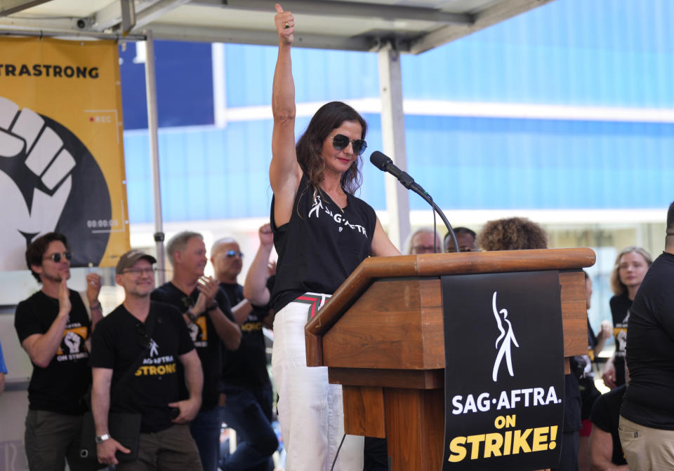 Actor Jill Hennessy speaks during the SAG-AFTRA "Rock the City for a Fair Contract" rally in Times Square on Tuesday, July 25, 2023, in New York. The actors strike comes more than two months after screenwriters began striking in their bid to get better pay and working conditions. (Photo by Charles Sykes/Invision/AP)