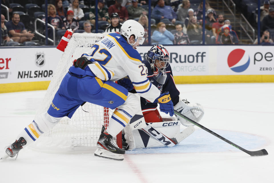 Columbus Blue Jackets' Jet Greaves, right, makes a save against Buffalo Sabres' Jack Quinn during the third period of a preseason NHL hockey game Wednesday, Sept. 28, 2022, in Columbus, Ohio. (AP Photo/Jay LaPrete)