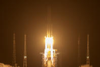 A Long March-5 rocket carrying the Chang'e 5 lunar mission lifts off at the Wenchang Space Launch Center in Wenchang in southern China's Hainan Province, early Tuesday, Nov. 24, 2020. China launched an ambitious mission on Tuesday to bring back material from the moon's surface for the first time in more than 40 years — an undertaking that could boost human understanding of the moon and of the solar system more generally. (AP Photo/Mark Schiefelbein)