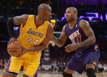 Dec 10, 2013; Los Angeles, CA, USA; Los Angeles Lakers guard Kobe Bryant (24) is defended by Phoenix Suns forward P.J. Tucker (17) at Staples Center. Kirby Lee-USA TODAY