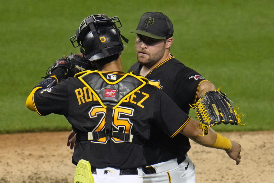 Pittsburgh Pirates relief pitcher David Bednar, right, celebrates with catcher Endy Rodriguez after getting the final out of a baseball game against the Atlanta Braves in Pittsburgh, Monday, Aug. 7, 2023. (AP Photo/Gene J. Puskar)