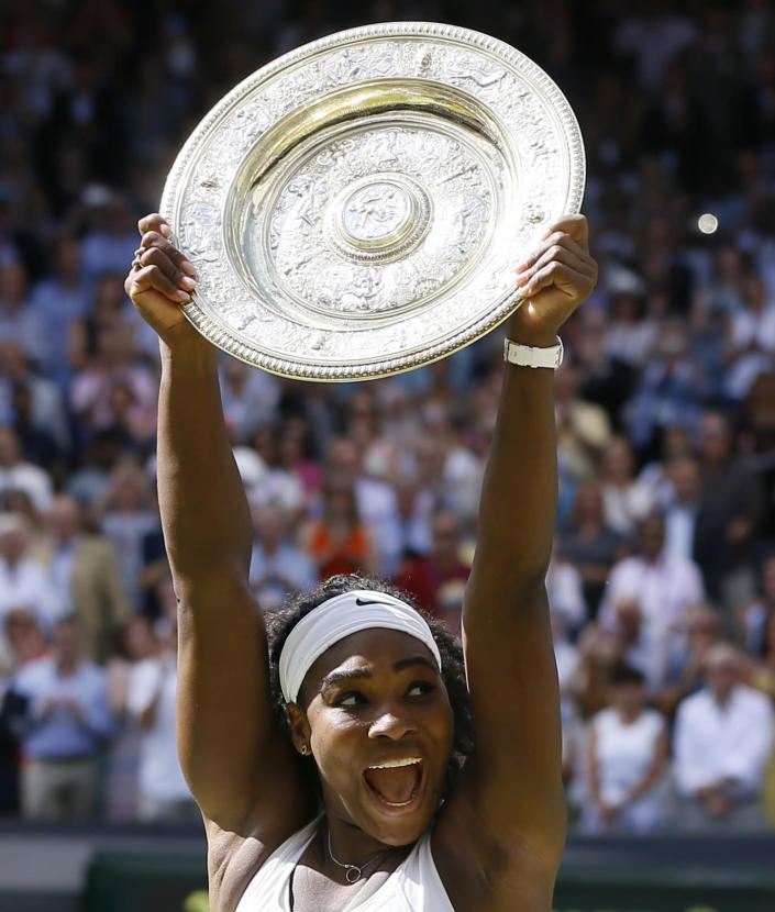 FILE - Serena Williams of the United States reacts as she holds the trophy after winning the women's singles final against Garbine Muguruza of Spain, at the All England Lawn Tennis Championships in Wimbledon, London, Saturday July 11, 2015. Saying “the countdown has begun,” 23-time Grand Slam champion Serena Williams announced Tuesday, Aug. 9, 2022, she is ready to step away from tennis so she can turn her focus to having another child and her business interests, presaging the end of a career that transcended sports. (AP Photo/Kirsty Wigglesworth, File)