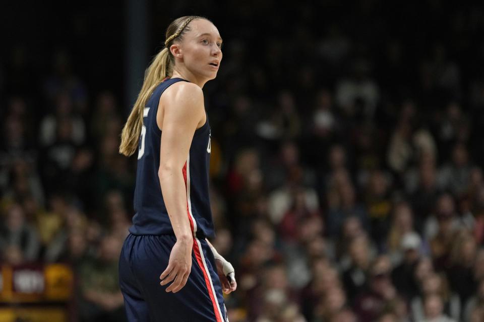 FILE - UConn guard Paige Bueckers (5) stands on the court during the first half of an NCAA college basketball game against Minnesota, Nov. 19, 2023, in Minneapolis. Bueckers, who missed much of the past two seasons with her own injuries, is expected to be a top pick in the WNBA draft, should she choose not to return to school. But she said Tuesday, Jan. 9, 2024, that the "deciding factor" may be her desire for more time and experiences with her college teammates. (AP Photo/Abbie Parr, File)