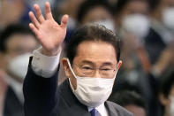 Japan’s former Foreign Minister Fumio Kishida waves as he won in the Liberal Democrat Party leadership election in Tokyo Wednesday, Sept. 29, 2021. Kishida has won the governing party leadership election and is set to be become the next prime minister. (Kyodo News via AP)