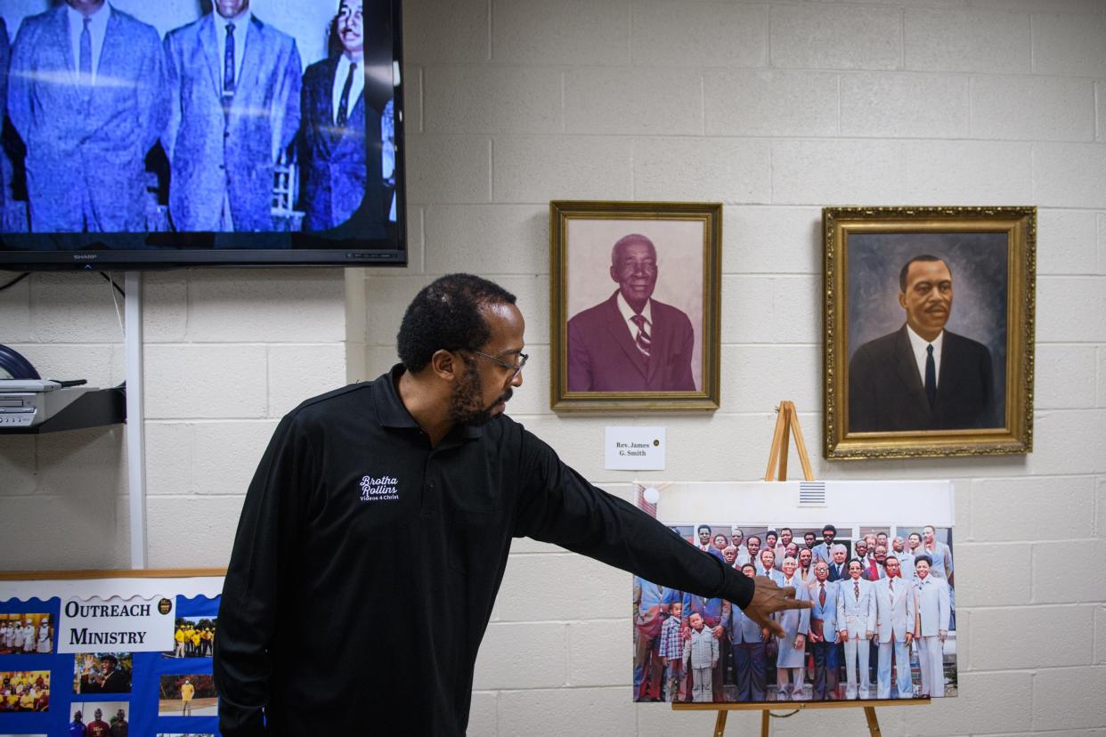 Louis Rollins points out members of the men of Mt. Sinai Missionary Baptist Church in a photo from the 1970s. The church has a rich history and a museum that explains it all.