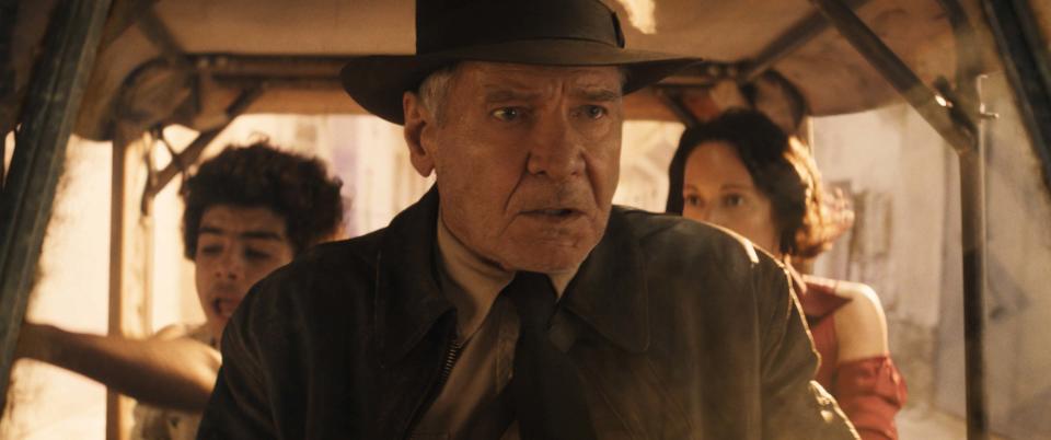 (L-R): Teddy (Ethann Isidore), Indiana Jones (Harrison Ford) and Helena (Phoebe Waller-Bridge) in Lucasfilm's INDIANA JONES AND THE DIAL OF DESTINY. (Lucasfilm)