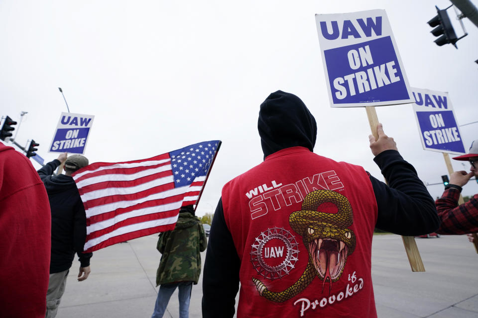 Members of the United Auto Workers strike outside of a John Deere plant, Wednesday, Oct. 20, 2021, in Ankeny, Iowa. About 10,000 UAW workers have gone on strike against John Deere since last Thursday at plants in Iowa, Illinois and Kansas. (AP Photo/Charlie Neibergall)