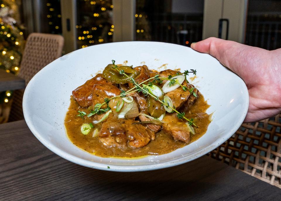 The pork tigania is a standout on Avli's menu, made with tender pork shoulder braised with green bell peppers, onion, honey, white wine and spices.