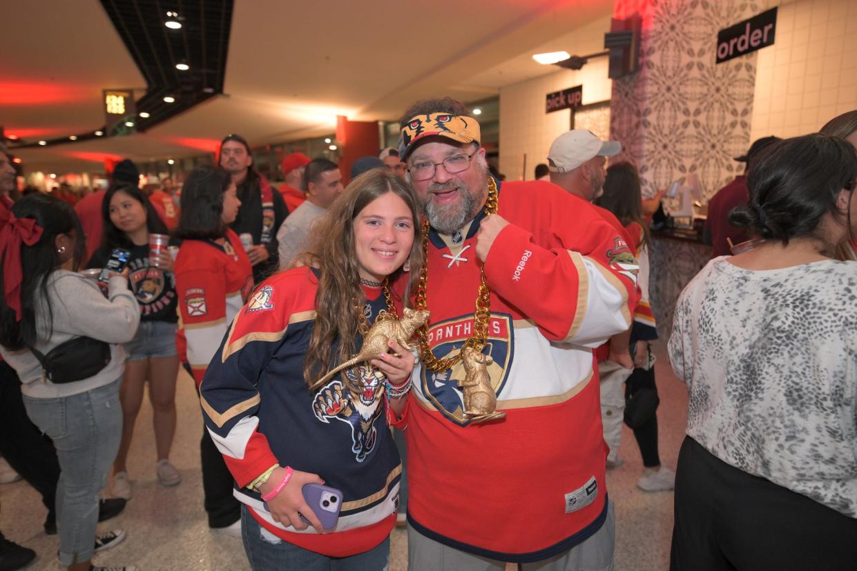 Florida Panthers fans Marissa Rutsy (left) and Jarett Rutsy (right) pose for a photo while waiting in a concessions line during the Panthers' watch party at Amerant Bank Arena (June 21, 2024).
