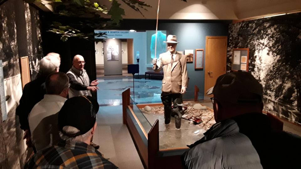 Frank Buethe addresses a North Liberty-based coffee group in a gallery at the Hoover Museum in West Branch which depicts the late President fly fishing. At 84, Buethe enjoys giving visitors information about Iowa’s only President that is not common knowledge.