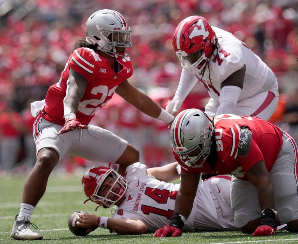 Sept. 9, 2023; Columbus, Oh., USA; 
Youngstown State Penguins quarterback Mitch Davidson (14) is taken down by Ohio State Buckeyes linebacker Steele Chambers (22) and Ohio State Buckeyes defensive tackle Jaden McKenzie (90) during the second half of Saturday's NCAA Division I football game at Ohio Stadium.