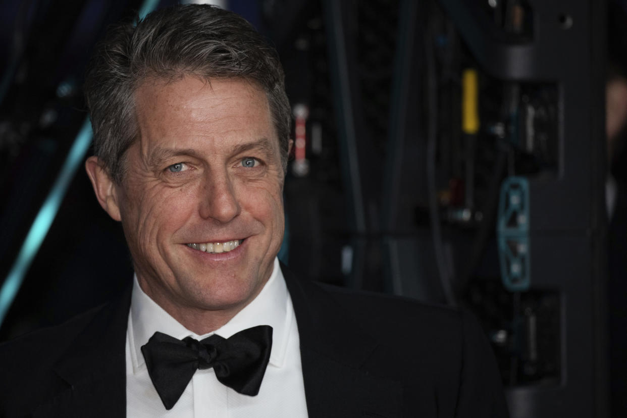 Hugh Grant poses for photographers upon arrival at the Bafta Film Awards, in central London, Sunday, Feb. 2 2020. (Photo by Vianney Le Caer/Invision/AP)