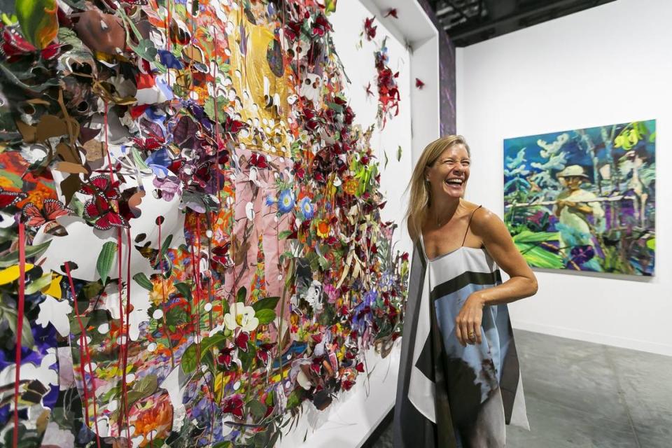 Kathryn Mikesell, an art collector and an art patron, looks at work by Ebony G. Patterson and Maia Cruz Palileo during Art Basel at the Miami Beach Convention Center on Wednesday, December 4, 2019.