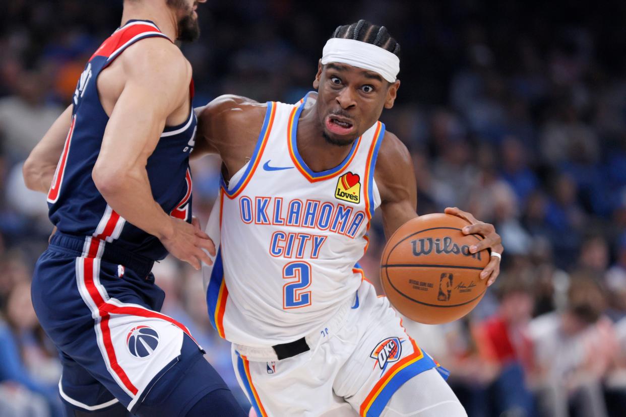 Oklahoma City Thunder guard Shai Gilgeous-Alexander (2) goes past Washington Wizards guard Landry Shamet (20) during an NBA basketball game between the Oklahoma City Thunder and the Washington Wizards at Paycom Center in Oklahoma City, Friday, Feb. 23, 2024.