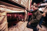 Ayyad kneels before the 14-pointed star marking the birthplace of Jesus, according to tradition, inside the Grotto at the Church of the Nativity (AFP/HAZEM BADER)