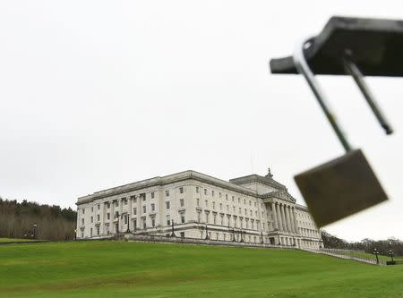 The Parliament Buildings at Stormont are seen behind a padlock on the railings, a day after deputy first minister Martin McGuinness resigned, throwing the devolved joint administration into crisis, in Belfast Northern Ireland, January 10, 2017. REUTERS/Clodagh Kilcoyne