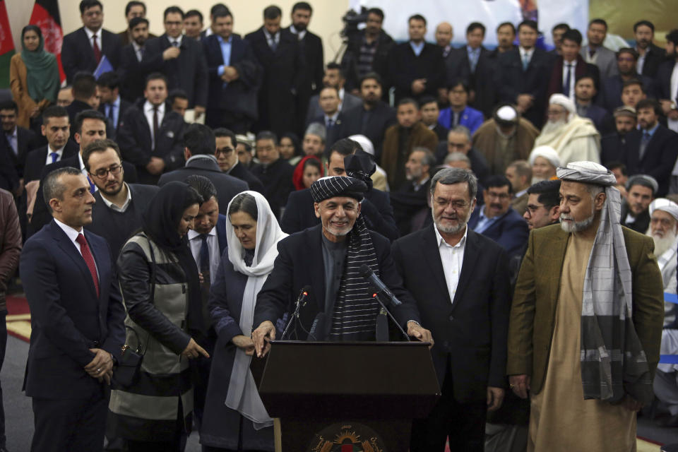 Afghanistan's President Ashraf Ghani, center, speaks to journalists after arriving to register as a candidate for the presidential election at the Independent Elections Commission, in Kabul, Afghanistan, Sunday, Jan. 20, 2019. Ghani and Chief Executive Abdullah Abdullah on Sunday registered to run for president later this year, setting up a rematch after a bitterly disputed 2014 vote led to a power-sharing agreement brokered by the United States. (AP Photo/Rahmat Gul)