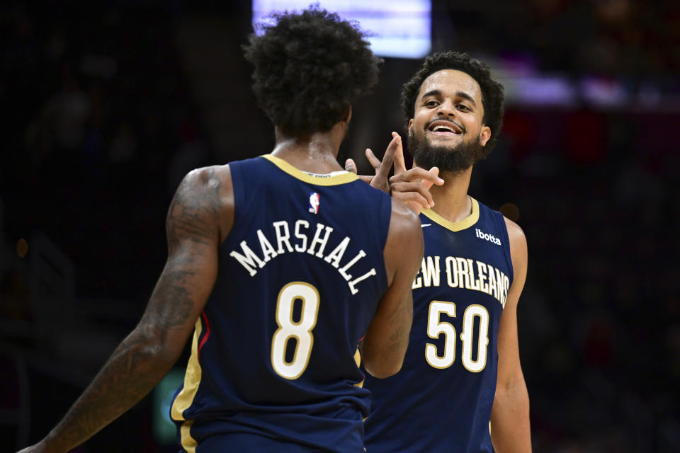 New Orleans Pelicans forward Jeremiah Robinson-Earl, front, and forward Naji Marshall (8) celebrate after the Pelicans defeated the Cavaliers 123-104 in an NBA basketball game Thursday, Dec. 21, 2023, in Cleveland. (AP Photo/David Dermer)